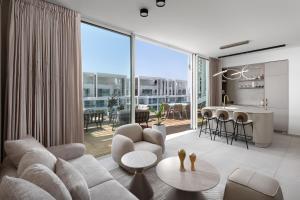 a living room with a couch and a table at Penthouses 42 Residence by Brown in Eilat