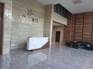 a lobby of a building with a stone wall at Solaris in Christiansborg +12 photos
