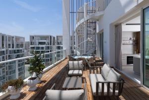 a balcony with furniture and a view of a city at Penthouses 42 Residence by Brown in Eilat