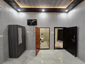 a bathroom with two open doors and a toilet at Royal Rani Residency in Ayodhya