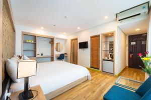 a bedroom with a bed and a living room at Gemini Saigon LUXURY in Ho Chi Minh City