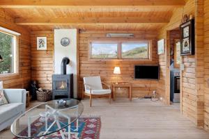 a living room with a wood cabin with a fireplace at OH456-Storvorde-Kystvej-173 in Storvorde