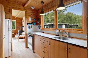 a kitchen with a sink and a window in a cabin at OH456-Storvorde-Kystvej-173 in Storvorde +20 photos