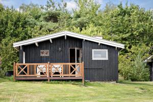 a black house with a wooden fence in front of it at OH456-Storvorde-Kystvej-173 in Storvorde