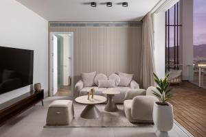 a living room with a couch and a table at Penthouses 42 Residence by Brown in Eilat