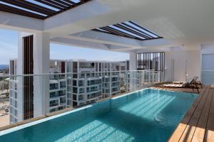 a swimming pool on the roof of a building at Penthouses 42 Residence by Brown in Eilat