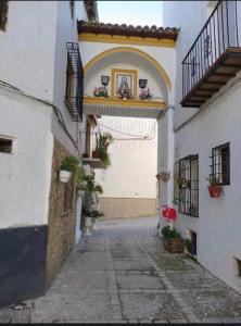 an alley in a town with white buildings at Poseidón in Quesada