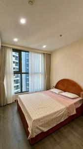 a bedroom with a large bed with a large window at Ruby's Home The Ruby Hạ Long in Ha Long +48 photos
