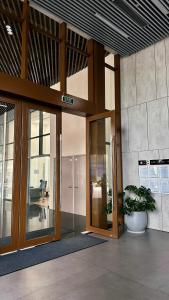 an office building with glass doors and a potted plant at Ruby's Home The Ruby Hạ Long in Ha Long
