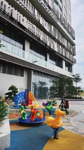 a playground in front of a building with childrens play equipment at Ruby's Home The Ruby Hạ Long in Ha Long