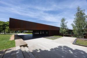 a large building with a large wooden structure at Le Cyclamens - MC et JC in Onet le Château