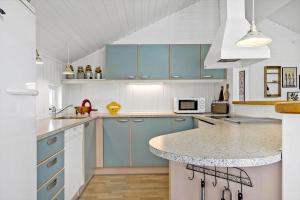 a kitchen with blue cabinets and a counter top at OH496-Hadsund-Kaeragervej-12 in Hadsund +23 photos