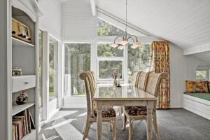 a dining room with a table and chairs and a window at OH496-Hadsund-Kaeragervej-12 in Hadsund