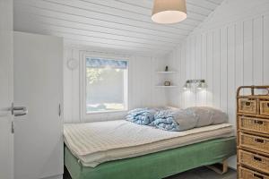 a bedroom with a bed with a window at OH496-Hadsund-Kaeragervej-12 in Hadsund