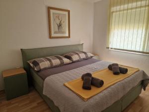 a bedroom with a bed with two towels on it at Apartments Dream House Zaton in Zaton +46 photos