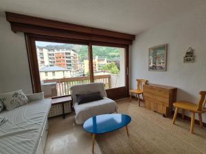 a living room with a couch and a chair at Studio centre Bourg-Saint-Maurice in Bourg-Saint-Maurice