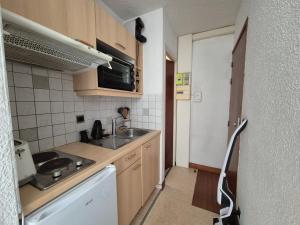 a small kitchen with a sink and a dishwasher at Studio centre Bourg-Saint-Maurice in Bourg-Saint-Maurice