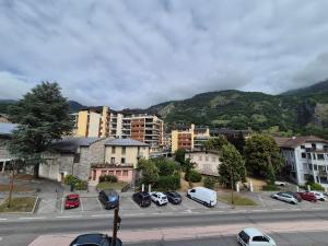 a city with cars parked in a parking lot at Studio centre Bourg-Saint-Maurice in Bourg-Saint-Maurice
