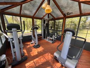 a gym with treadmills and exercise bikes in a room at Cascina Scova Resort in Pavia