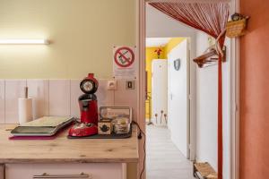 a kitchen with a counter with a red blender on it at Le Cyclamens - MC et JC in Onet le Château