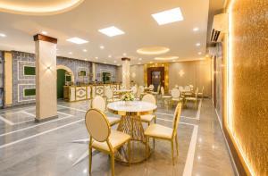a dining area with tables and chairs in a restaurant at Hotel Vibe Blue Sec 70, Near Kailash Hospital & Sec 61 -52 Metro in Noida