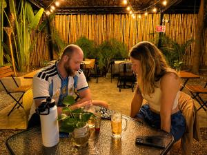 a man and a woman sitting at a table at THE PLACE Hostel Phnom Penh in Phnom Penh