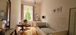 a living room with a couch and a table at Pension Seeschlösschen in Mölln