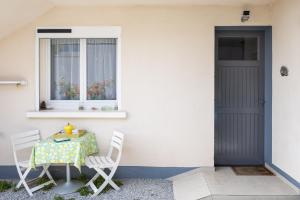 a table and two chairs and a window at Le Cyclamens - MC et JC in Onet le Château +14 photos