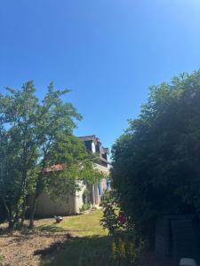 a house with trees in front of it at Gîte de campagne in Candor +7 photos
