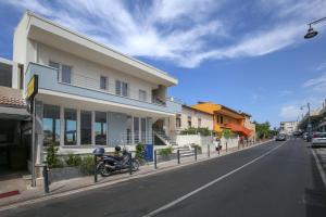 a motorcycle parked on the side of a street at Suite HollidayHouse - vista mare in Castelsardo