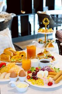 a table topped with plates of food on a table at The Residence on Thonglor by UHG in Bangkok