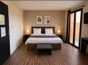a bedroom with a large bed with two lamps at La Bourse in Bagnols-sur-Cèze +15 photos