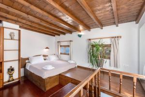 a bedroom with a bed and a balcony at Crystal Dream Paros in Kampos Paros