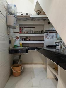 a kitchen with a black counter and a sink at Royal Rani Residency in Ayodhya