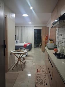 a kitchen and living room with a bed in the background at The Loftel in Ruaka