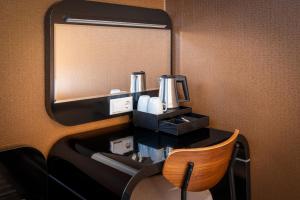 a vanity with a mirror and a chair in a room at Hotel Mansion in Amsterdam
