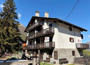 a building with balconies on the side of it at Borealis - VOTRE MAISON in Cogne
