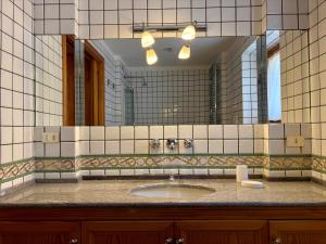 a bathroom with a sink and a large mirror at Borealis - VOTRE MAISON in Cogne +24 photos
