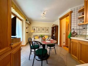 a kitchen and dining room with a table and chairs at Borealis - VOTRE MAISON in Cogne