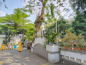 a street with trees and plants on a wall at SNUZ Hotel Menteng in Jakarta