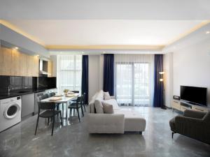 a living room with a white couch and a table at Silence garden suite iki yatak odalı daire in Alanya