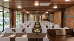 a room with tables and white chairs in a room at Wellness Resort Rayong Managed by the SCN in Ban Huai Pla Kang +194 photos