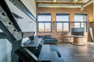 a living room with a couch and a tv at Le Venise Factory in Martigues +6 photos