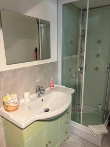 a bathroom with a sink and a shower at Monolocale Zefiro in Elmas