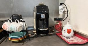 a kitchen counter with a coffee maker and other appliances at Monolocale Zefiro in Elmas +11 photos