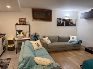 a living room with a couch and a table at Monolocale Zefiro in Elmas