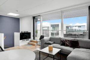 a living room with a couch and a tv at 0385-Romo-Hollaenderstraedet-42 in Høm