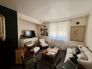 a living room with a couch and a table at Maison familiale in Paulhac