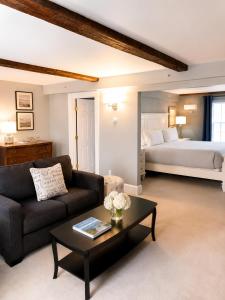 a living room with a couch and a bed at Bellevue House in Newport