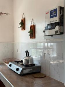 a tea kettle on top of a stove in a kitchen at Miti Retreat Nanyuki in Naro Moru